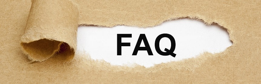 The acronym FAQ - Frequently Asked Questions appearing behind torn brown paper.